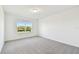 Cozy bedroom with neutral carpet, natural light from the window, and a minimalist aesthetic at 6233 Golden Beach Dr, Apollo Beach, FL 33572
