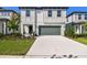 Charming two-story home with a manicured front yard and a two-car garage and a concrete driveway at 6233 Golden Beach Dr, Apollo Beach, FL 33572