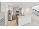 Bright kitchen features stainless steel appliances, gray cabinets, an island, and close access to stairs at 6233 Golden Beach Dr, Apollo Beach, FL 33572