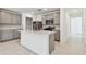 Modern kitchen with gray cabinets, stainless steel appliances, white countertops, and a central island with a sink at 6233 Golden Beach Dr, Apollo Beach, FL 33572