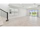 Bright living room features tile flooring, a sliding glass door to the backyard, and a staircase to the upper level at 6233 Golden Beach Dr, Apollo Beach, FL 33572