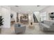 Open-concept living room boasts neutral tones, tile floors, and seamlessly connects to the modern kitchen and dining area at 6233 Golden Beach Dr, Apollo Beach, FL 33572