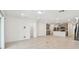 Spacious living room showcases tile floors, ample natural light, and an open layout connecting to the modern kitchen area at 6233 Golden Beach Dr, Apollo Beach, FL 33572
