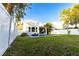 Lovely backyard with lush green lawn, a sparkling swimming pool, and white privacy fence at 2246 Fiesta Dr, Sarasota, FL 34231