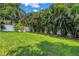 Large backyard with privacy fence and beautiful tropical landscaping at 2246 Fiesta Dr, Sarasota, FL 34231