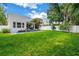 Expansive backyard features a refreshing pool and lush green grass, perfect for outdoor activities at 2246 Fiesta Dr, Sarasota, FL 34231