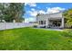 Expansive backyard featuring a pristine lawn, modern home, and inviting swimming pool at 2246 Fiesta Dr, Sarasota, FL 34231