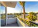 Balcony view overlooking the neighborhood, featuring metal railings and a palm tree at 2246 Fiesta Dr, Sarasota, FL 34231