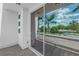 Balcony view featuring palm trees, blue skies, and slider to living area at 2246 Fiesta Dr, Sarasota, FL 34231