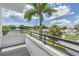 Balcony view featuring blue skies, palm trees, and street view at 2246 Fiesta Dr, Sarasota, FL 34231
