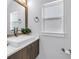 Bathroom features a vessel sink, modern faucet, framed mirror, and ample natural light from a window at 2246 Fiesta Dr, Sarasota, FL 34231