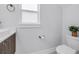 Modern bathroom features a toilet, vessel sink, vanity, and natural light from the privacy window at 2246 Fiesta Dr, Sarasota, FL 34231