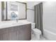 Bathroom with stylish vanity, framed mirror, and tiled shower/tub combination at 2246 Fiesta Dr, Sarasota, FL 34231