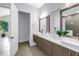 Dual vanity bathroom with undermount sinks, modern mirrors, and sleek lighting fixtures at 2246 Fiesta Dr, Sarasota, FL 34231