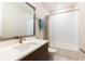 Bathroom featuring a large mirror, white countertop, and a tub with shower at 2246 Fiesta Dr, Sarasota, FL 34231