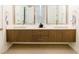 Modern bathroom featuring double sinks, wood cabinets, and a sleek countertop at 2246 Fiesta Dr, Sarasota, FL 34231