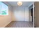 Bright bedroom featuring statement lighting, large window, and closet with custom shelving at 2246 Fiesta Dr, Sarasota, FL 34231