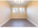 Bedroom with two windows and dark, modern floors and light yellow walls at 2246 Fiesta Dr, Sarasota, FL 34231