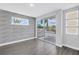 Bedroom featuring textured wall, balcony access, and wood-look flooring at 2246 Fiesta Dr, Sarasota, FL 34231