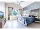 Spacious main bedroom with stylish accent wall, large window, and a ceiling fan at 2246 Fiesta Dr, Sarasota, FL 34231