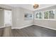 Bedroom featuring stylish wood flooring, natural light, and access to a bathroom at 2246 Fiesta Dr, Sarasota, FL 34231