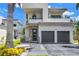 Modern two-story home boasts a two-car garage and contemporary design with a welcoming entrance at 2246 Fiesta Dr, Sarasota, FL 34231