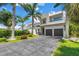 Contemporary two-story home with tropical landscaping and a two-car garage at 2246 Fiesta Dr, Sarasota, FL 34231