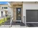 Modern front door with sidelights and stone accents at 2246 Fiesta Dr, Sarasota, FL 34231