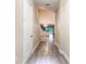 Bright hallway featuring modern flooring and view of open concept living space at 2246 Fiesta Dr, Sarasota, FL 34231