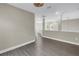 Light filled hallway with gray wood-look floors and stylish white columns at 2246 Fiesta Dr, Sarasota, FL 34231