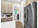 Modern kitchen featuring stainless steel appliances and sleek cabinets with easy access to a laundry room at 2246 Fiesta Dr, Sarasota, FL 34231