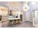 Open-concept living area with a modern kitchen, island seating, and elegant staircase at 2246 Fiesta Dr, Sarasota, FL 34231