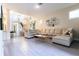 Inviting living room with large sectional sofa, modern decor, and access to upper floor at 2246 Fiesta Dr, Sarasota, FL 34231