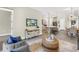 Open-concept living room featuring a TV, modern decor, and seamless flow to the kitchen at 2246 Fiesta Dr, Sarasota, FL 34231