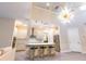 Spacious living room features a modern kitchen, high ceilings, and a statement chandelier at 2246 Fiesta Dr, Sarasota, FL 34231