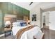 Stylish bedroom with a textured accent wall, plush bedding, and modern furnishings at 2246 Fiesta Dr, Sarasota, FL 34231