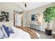 Bright main bedroom with neutral tones, vaulted ceiling, and a view of the outdoors at 2246 Fiesta Dr, Sarasota, FL 34231