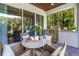 Inviting outdoor dining area with built-in grill and views of the lush greenery at 2246 Fiesta Dr, Sarasota, FL 34231