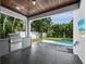 Wonderful covered patio area with outdoor kitchen and a relaxing view of the pool at 2246 Fiesta Dr, Sarasota, FL 34231