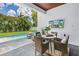 Outdoor living space with a pool, seating and a TV at 2246 Fiesta Dr, Sarasota, FL 34231