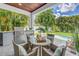 Covered outdoor dining area with a built-in grill overlooking the inviting pool at 2246 Fiesta Dr, Sarasota, FL 34231