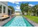 Refreshing backyard pool and outdoor seating with well-maintained lawn at 2246 Fiesta Dr, Sarasota, FL 34231