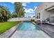 Private backyard pool with comfortable seating and lush green grass at 2246 Fiesta Dr, Sarasota, FL 34231