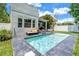 Beautiful pool with comfortable seating and lush landscaping creates a relaxing backyard oasis at 2246 Fiesta Dr, Sarasota, FL 34231