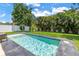 Backyard pool and lush tropical landscaping creates a private and relaxing oasis at 2246 Fiesta Dr, Sarasota, FL 34231