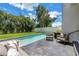 View of the pool with lounge chairs and lush landscaping at 2246 Fiesta Dr, Sarasota, FL 34231