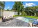 Backyard with a small pool and lounge seating at 2246 Fiesta Dr, Sarasota, FL 34231