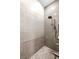 Modern shower with pebble flooring, gray subway tile and rain shower head at 2246 Fiesta Dr, Sarasota, FL 34231