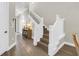 Elegant staircase with white railing and wood treads, leading to the upper level of the home at 2246 Fiesta Dr, Sarasota, FL 34231