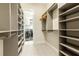 Organized walk-in closet with custom shelving and access to laundry room at 2246 Fiesta Dr, Sarasota, FL 34231